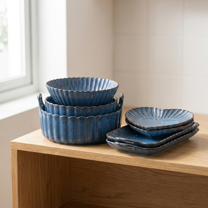 Stack of nested blue ribbed ceramic bowls on a kitchen counter, Kiyo Home 22-piece dinnerware set