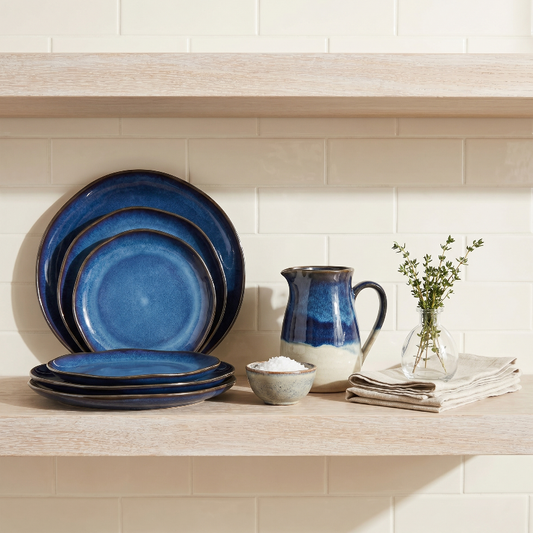 Blue wave edge ceramic dinner plates set of 4 styled on shelf with pitcher and cup