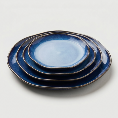Blue wave edge ceramic dinner plates stacked on white background
