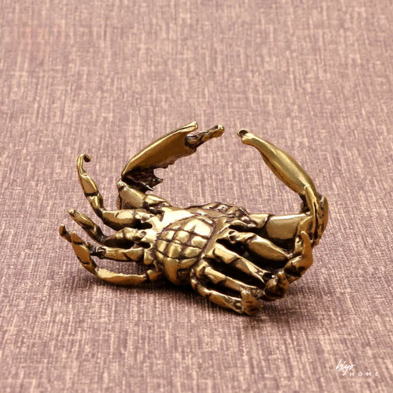 Bronze crab sculpture on a textured brown background