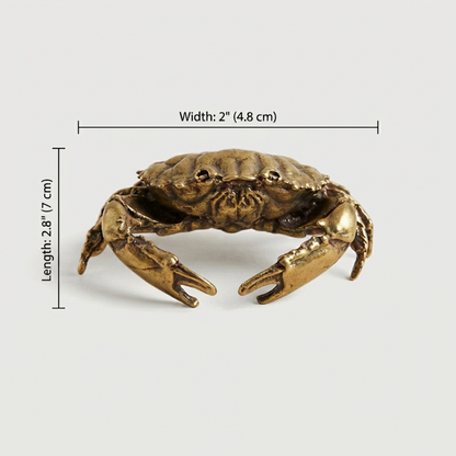 Bronze crab figurine with measurements on a white background