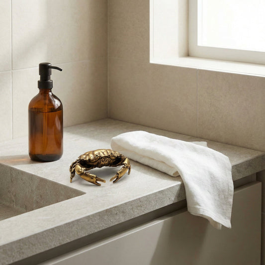 Bathroom counter with a bottle, towel, and decorative crab