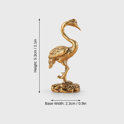 Dimensions graphic of a polished brass crane figurine on a round openwork base labeled Height 5.3cm / 2.1in and Base Width 2.3cm / 0.9in
