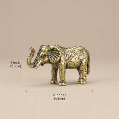 Bronze elephant figurine with measurements on a beige background