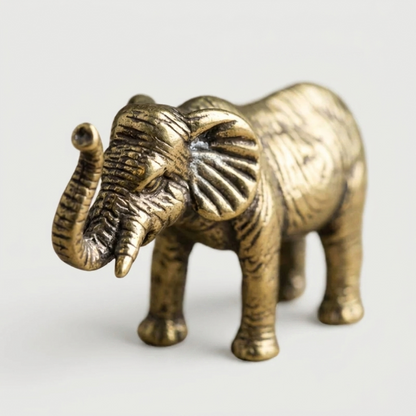 Brass elephant figurine on white background