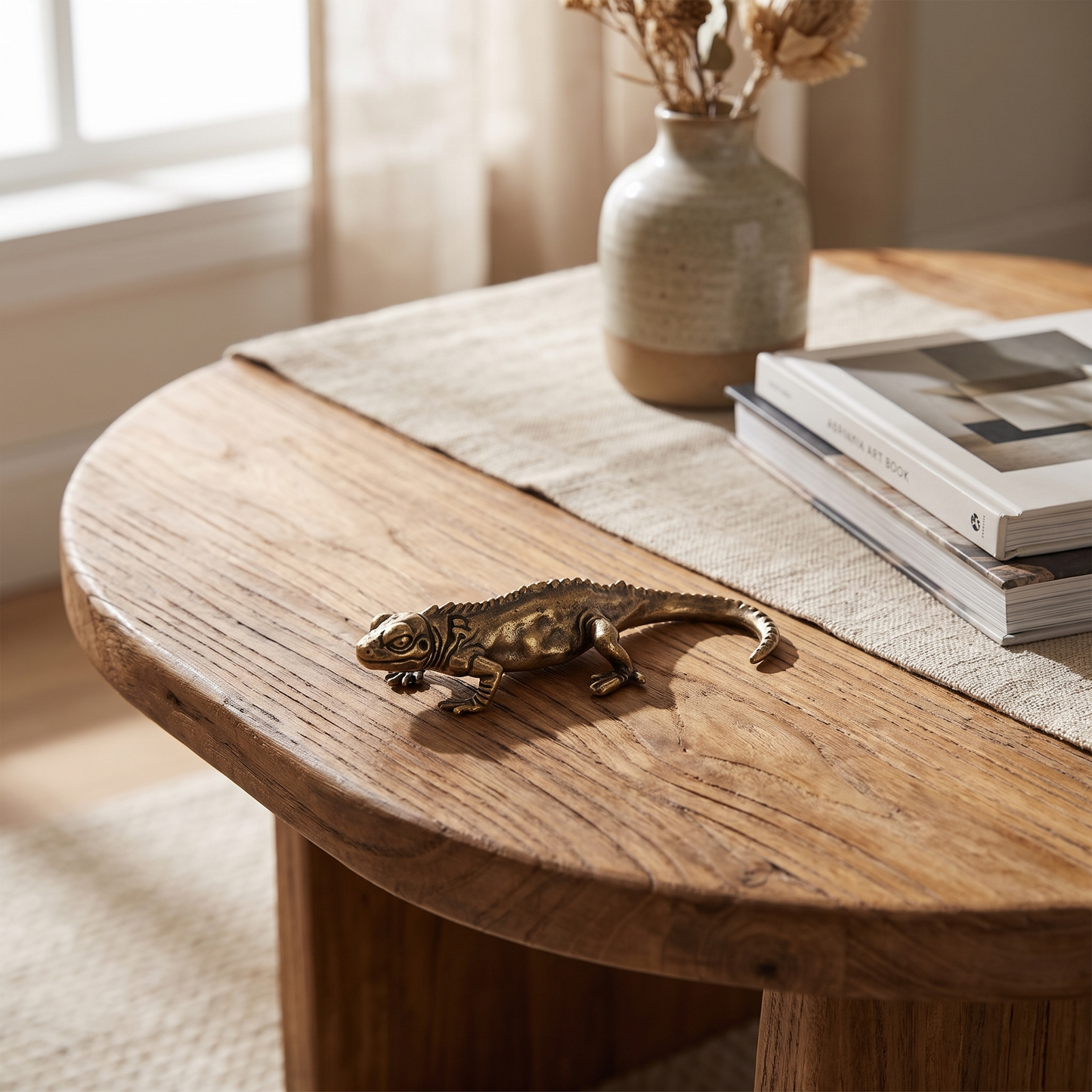 Brass reptile figurine styled on a console table