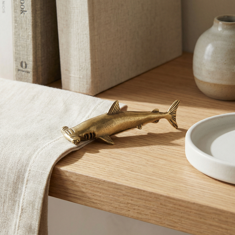Brass hammerhead shark on modern desk