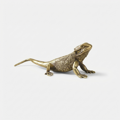 Bronze lizard figurine on a white background
