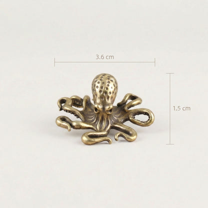 Brass octopus sculpture with labeled dimensions showing size measurements.