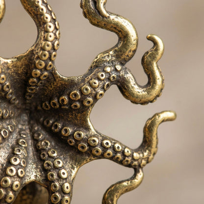 Close-up of a bronze octopus sculpture against a blurred background