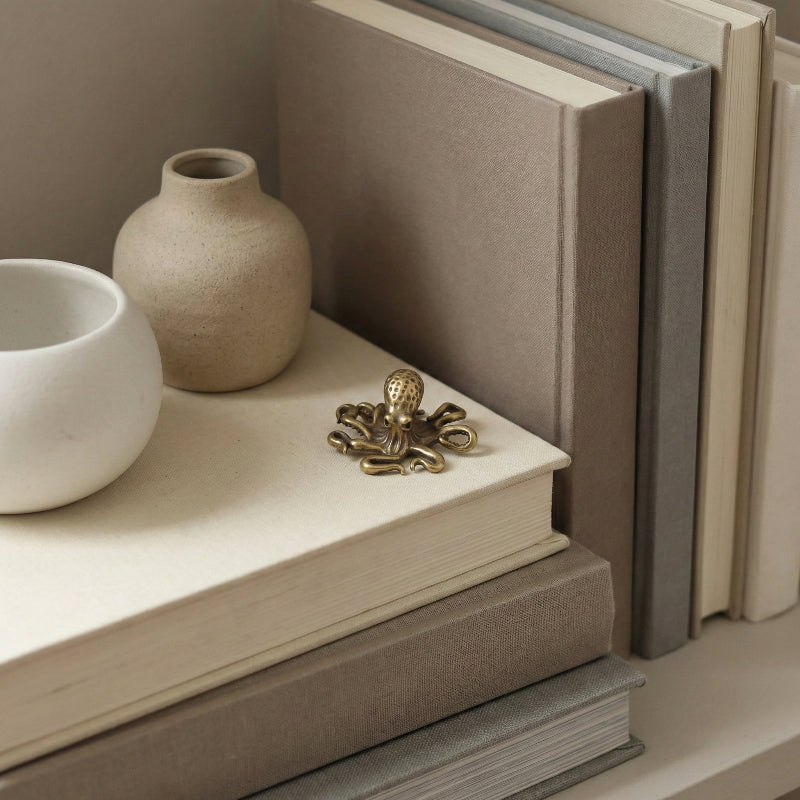 Decorative brass octopus figurine styled as a coastal home accent.