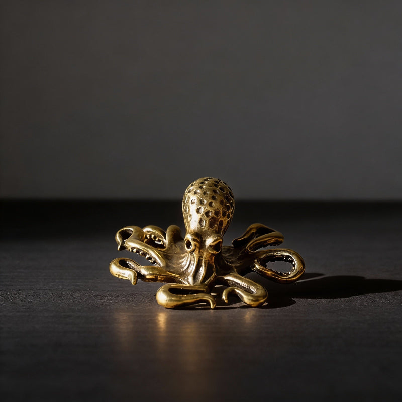 Gold octopus figurine on a dark surface
