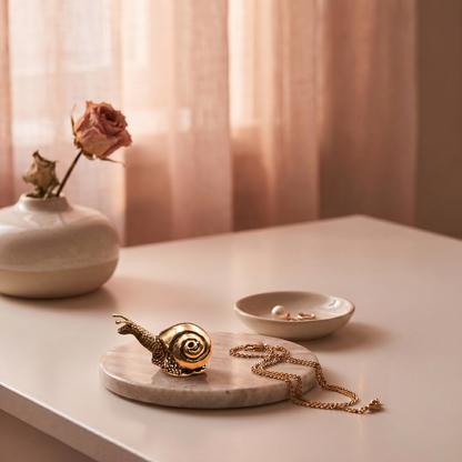Brass snail figurine on vanity tray with jewelry dish
