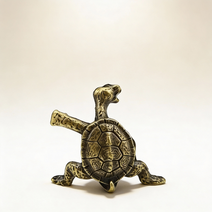 Bronze turtle figurine on a beige background