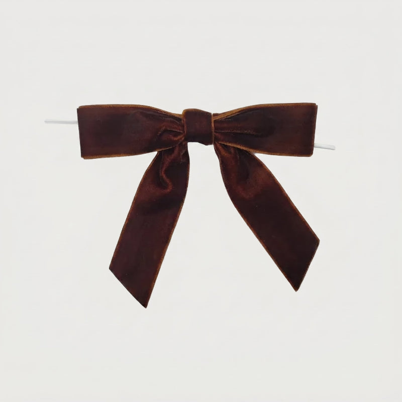 Brown velvet bow on white background