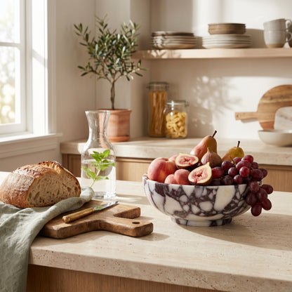 Calacatta marble bowl on kitchen counter with fruit and pastries