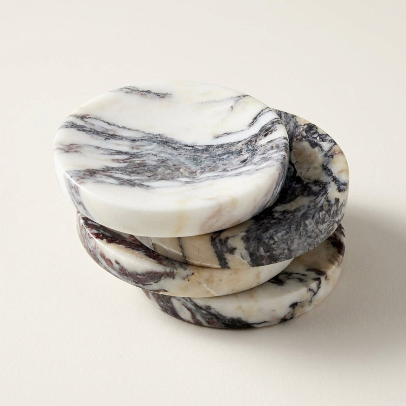 Stack of marble-patterned coasters on a light background