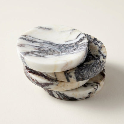 Stack of marble-patterned coasters on a light background
