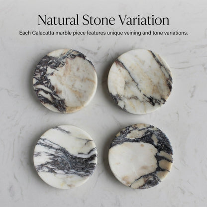 Four marble coasters with natural variations on a marble surface.
