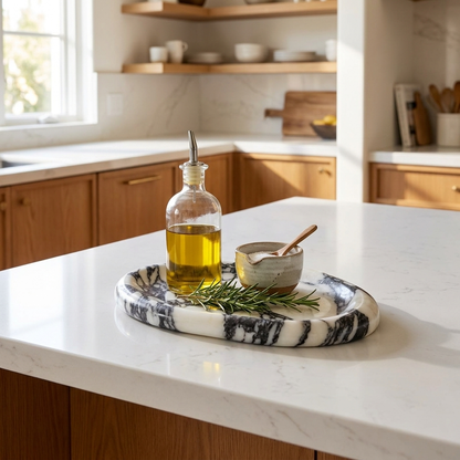 Calacatta marble tray on a kitchen island holding olive oil, Kiyo Home