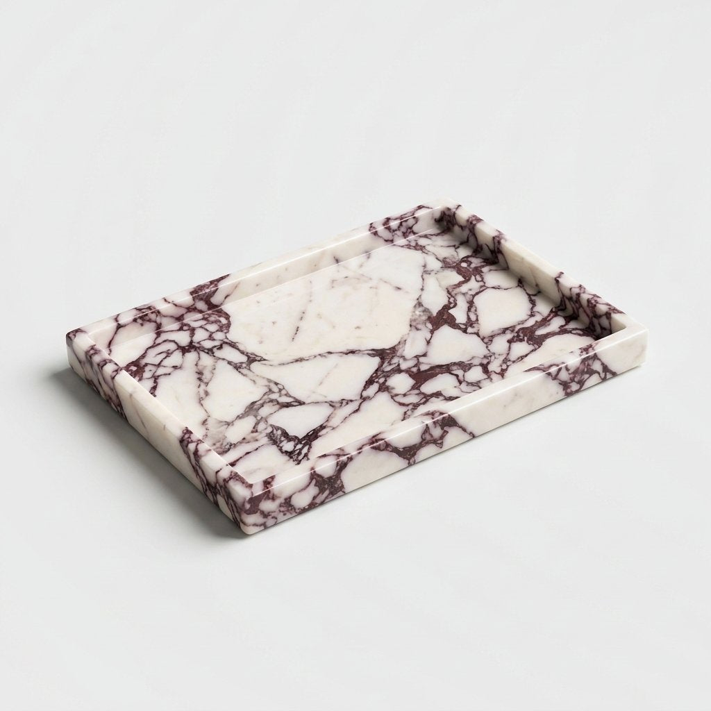 Empty white marble tray with burgundy veining and a low straight rim on a plain light grey backdrop