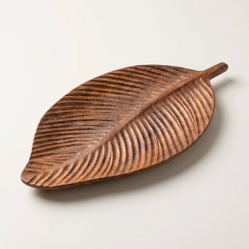 Wooden leaf-shaped tray on a light background