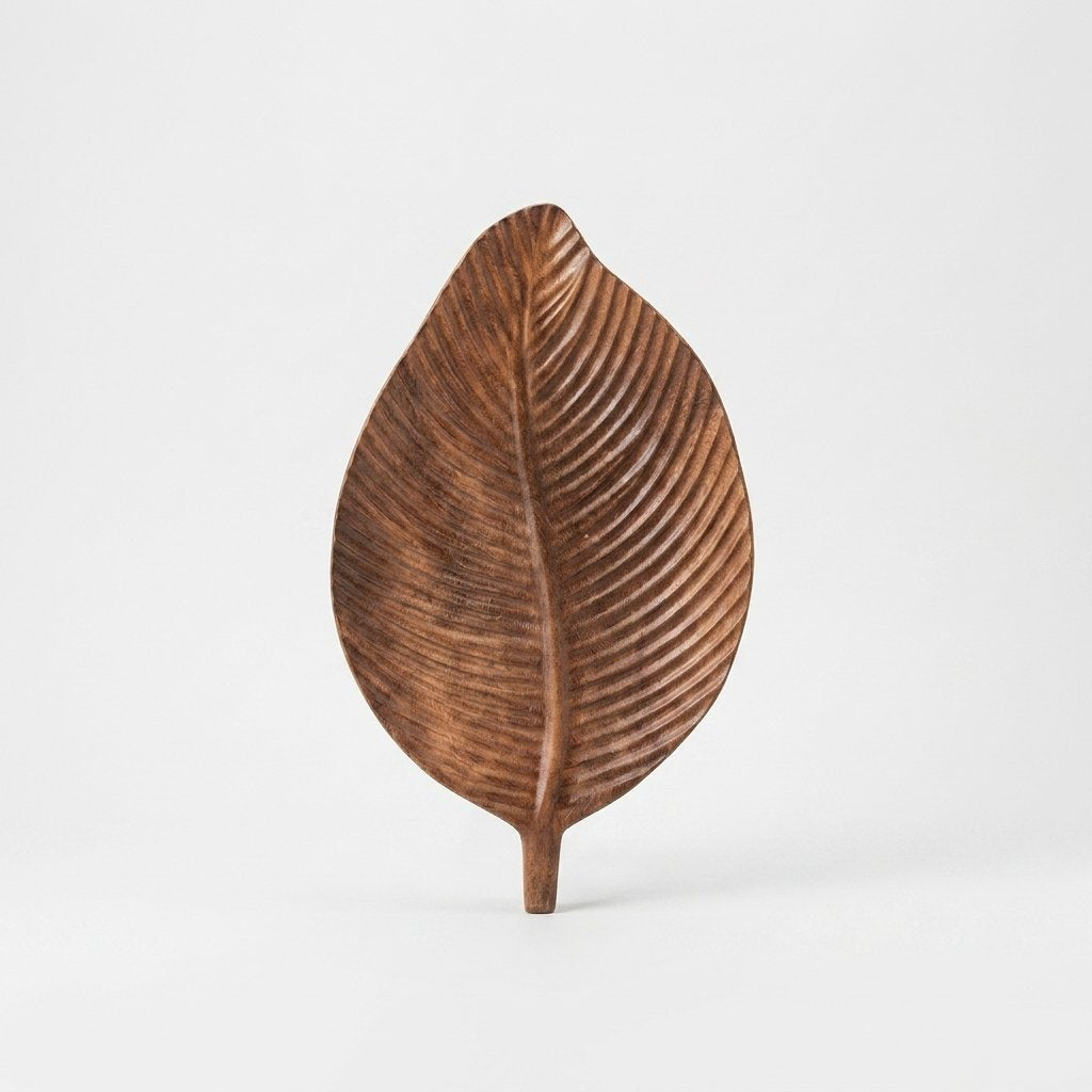 Dark wood Carved Leaf Serving Tray standing upright, hero shot on a clean off-white background