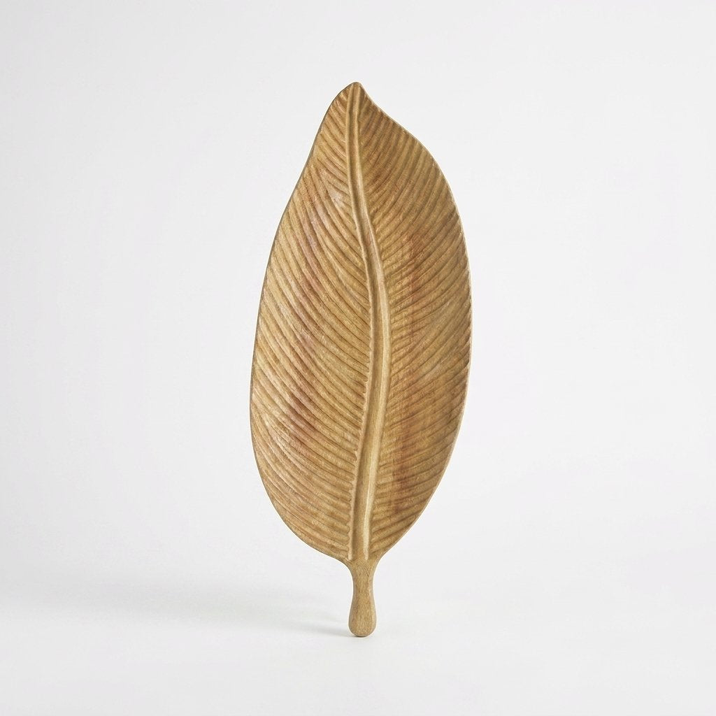 Light wood Carved Leaf Serving Tray standing upright, alternate hero shot on a clean off-white background