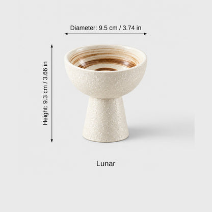 Lunar cream textured ceramic pedestal dessert bowl with a brown swirl inside and dimensions labeled diameter 9.5 cm (3.74 in) and height 9.3 cm (3.66 in)