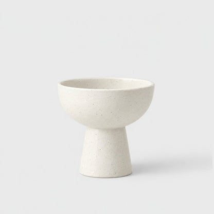 Single speckled white matte ceramic pedestal dessert bowl on a light grey background