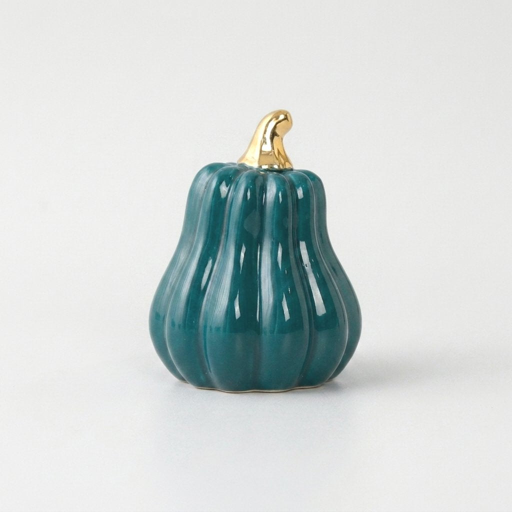 Teal-blue ceramic gourd with a gold stem on a white background