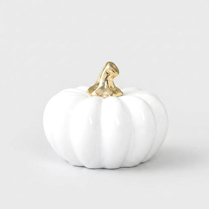 White ceramic pumpkin with a gold stem on a white background, alternate angle
