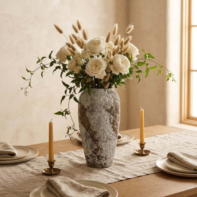 Ceramic rustic circular vases with flowers on dining table