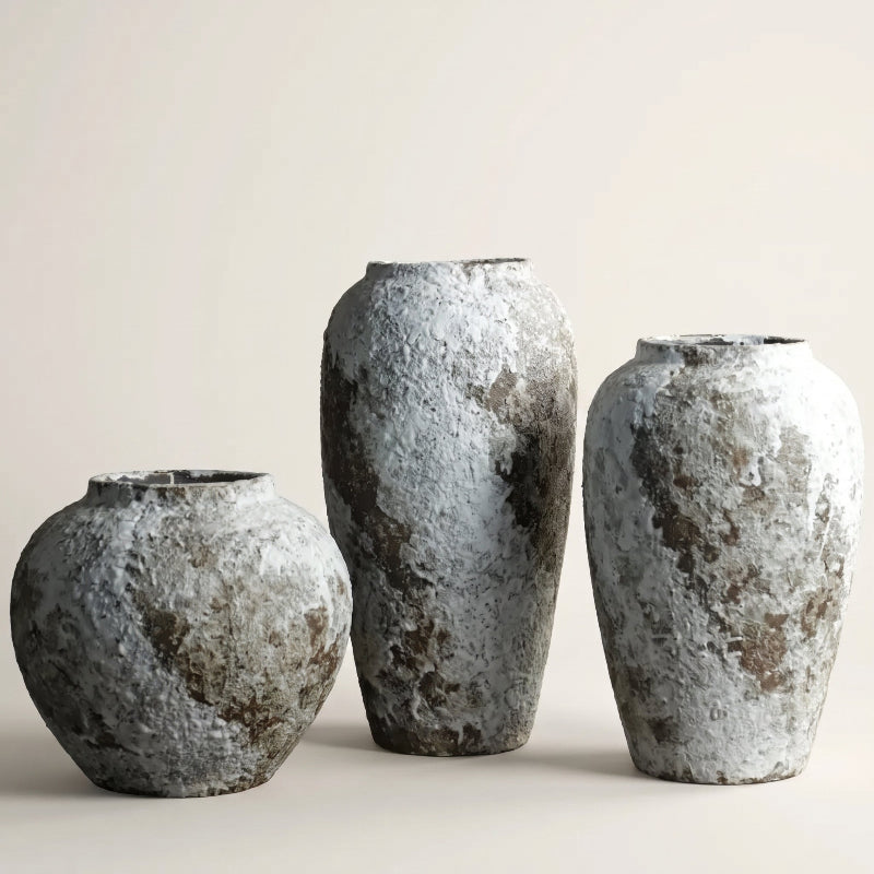 Set of ceramic rustic circular vases on white background