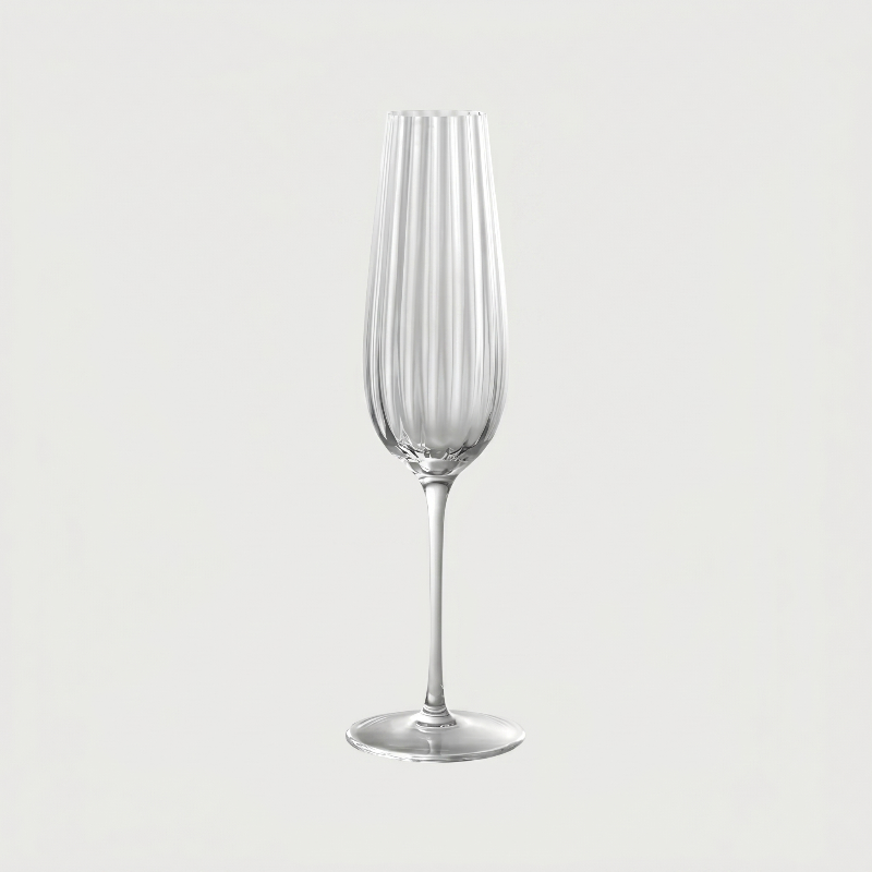 Clear glass flute on a light gray background