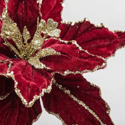 Close-up of red velvet poinsettia petals with gold glitter edging and stamens