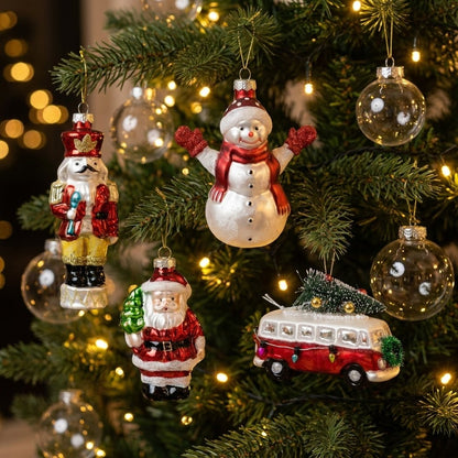 Nutcracker, snowman, Santa, and bus ornaments hanging on a Christmas tree