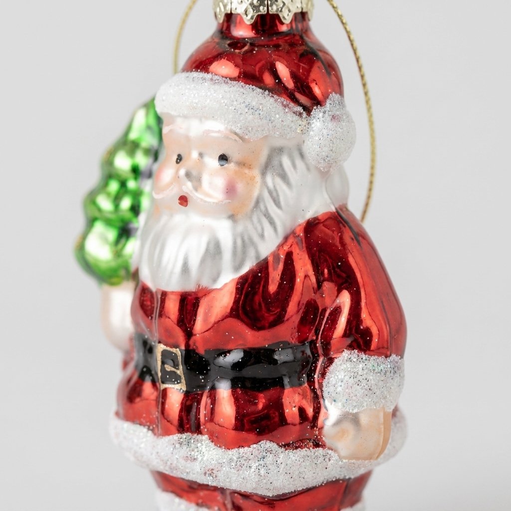 Close-up of Santa ornament showing painted face and glitter trim detail