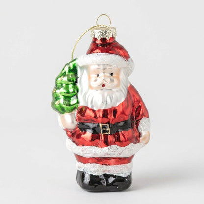 Hand-painted glass Santa ornament holding a small tree