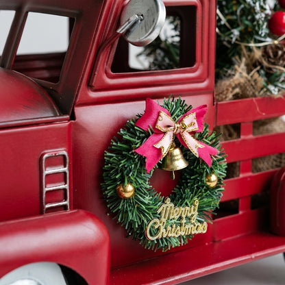 Close-up of wreath detail with "Merry Christmas" text on truck door