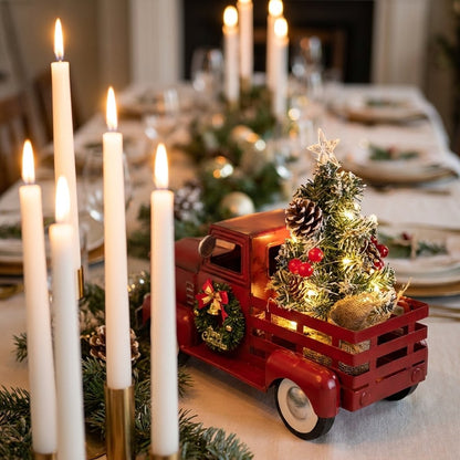 Christmas truck ornament centerpiece on table set with tall candles