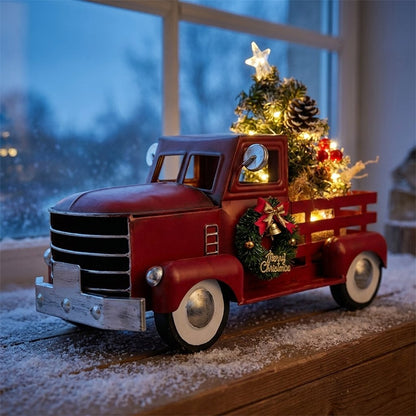 Christmas truck ornament on a snow-dusted windowsill at night