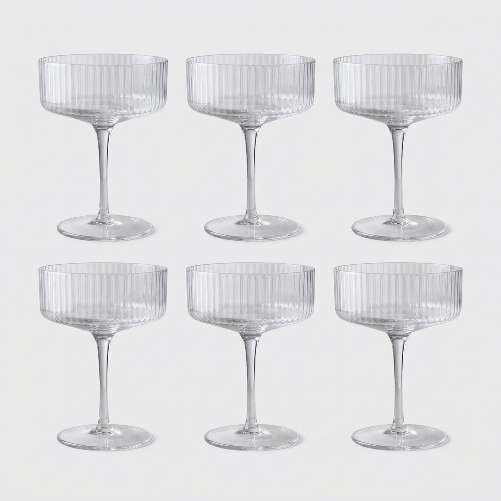 Set of 6 clear ribbed hand-blown crystal coupe cocktail glasses on a clean off-white background