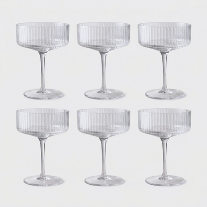 Set of 6 clear ribbed hand-blown crystal coupe cocktail glasses on a clean off-white background