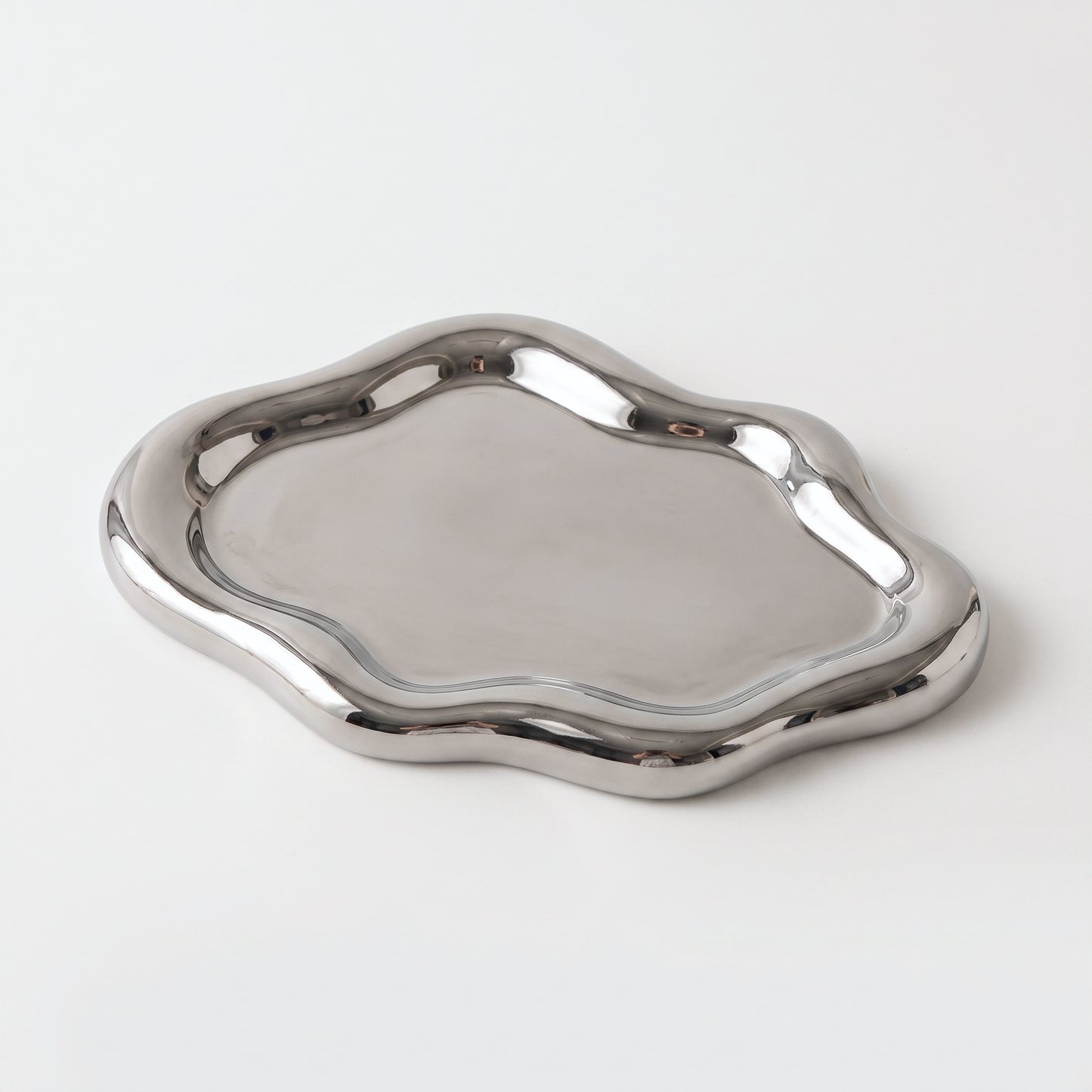 Silver ceramic cloud-shaped jewelry catchall on an off-white background