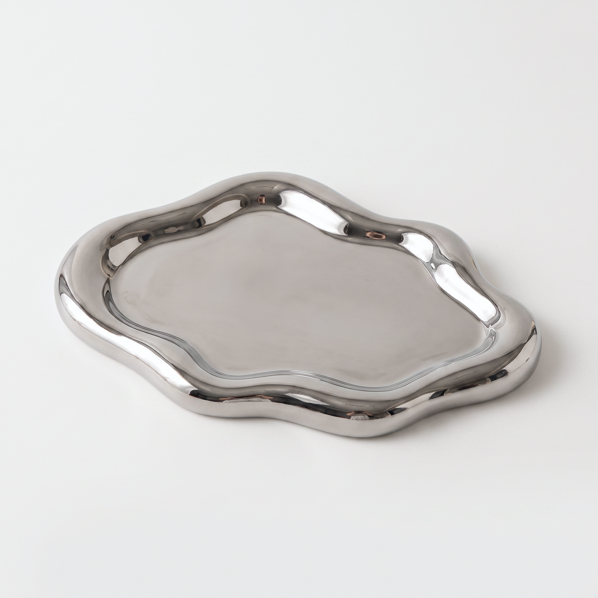 Silver ceramic cloud-shaped jewelry catchall on an off-white background