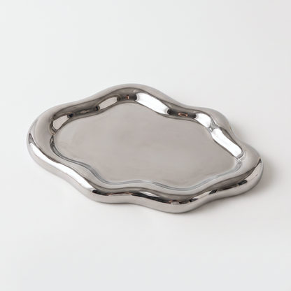 Silver ceramic cloud-shaped jewelry catchall on an off-white background