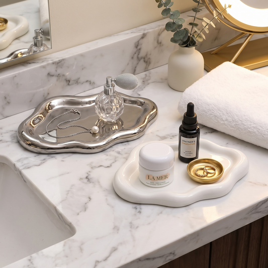 Silver cloud jewelry tray on a marble bathroom counter holding jewelry