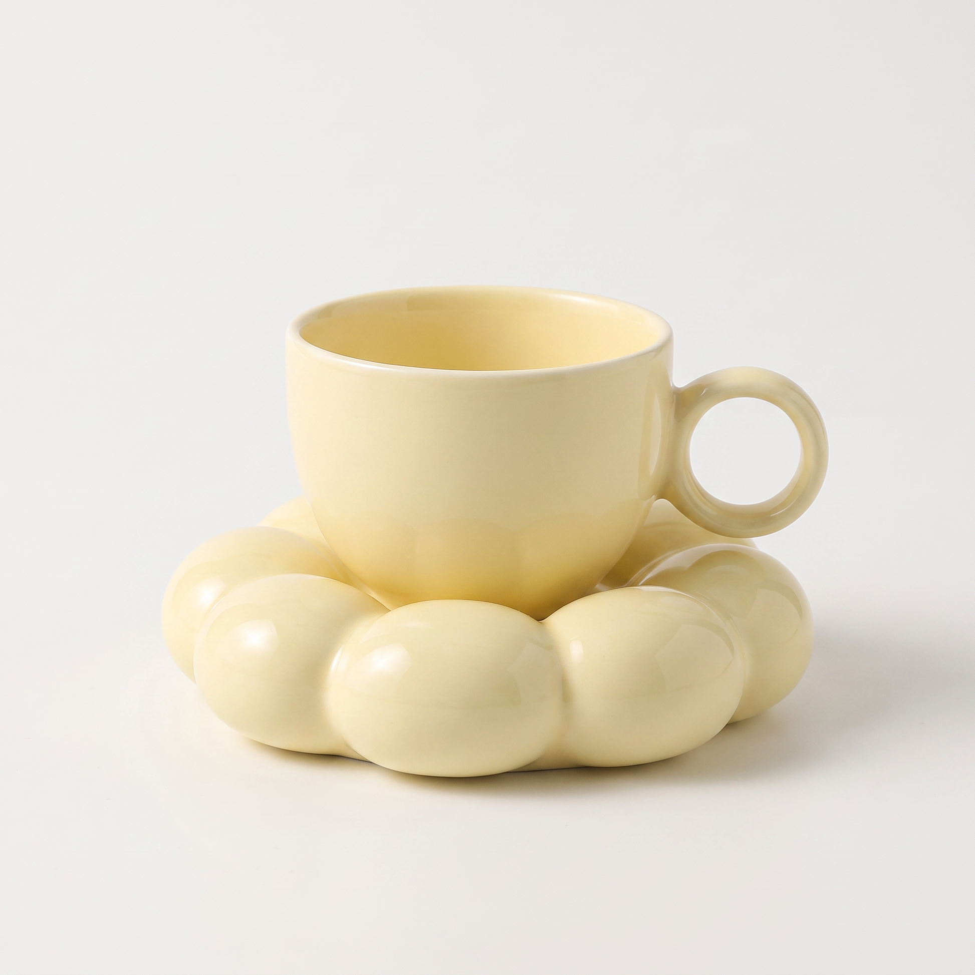 Yellow ceramic coffee mug on a cloud-shaped saucer, Kiyo Home cloud saucer mug set