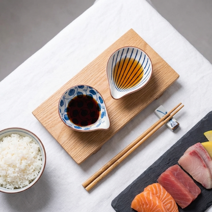Coastal ceramic dip dishes with chopsticks and sushi